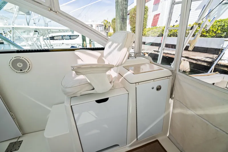 Slide: The Image of 2001 Rampage 38 Express boat interior with white captain's chair and storage. - 12