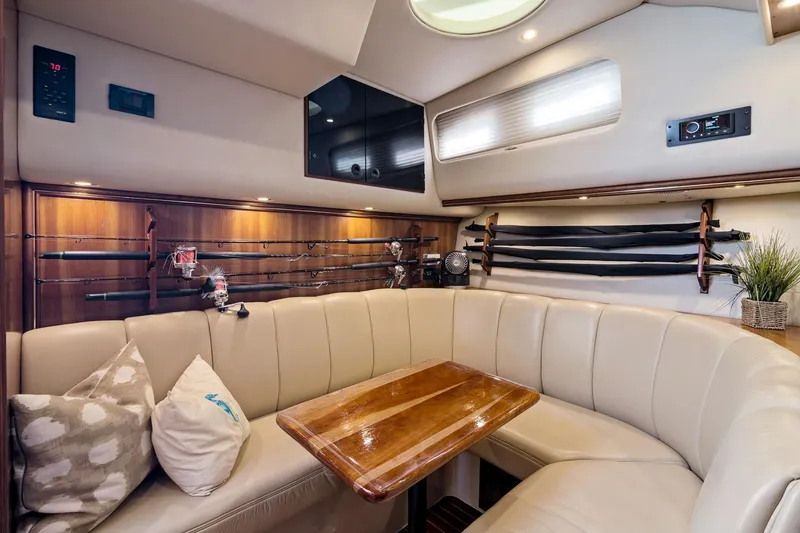 Slide: The Image of Luxurious interior of 2001 Rampage 38 Express yacht with fishing rods and cozy seating. - 13