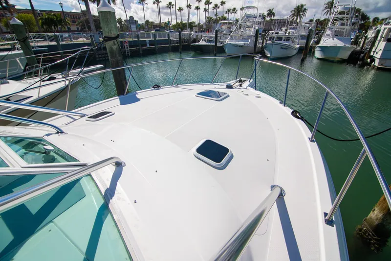 Slide: The Image of 2001 Rampage 38 Express yacht docked at marina, showcasing sleek deck design. - 21