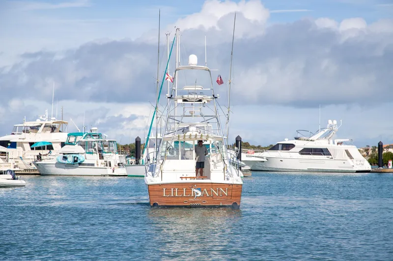 Slide: The Image of 2001 Rampage 38 Express boat in marina, surrounded by other yachts. - 3