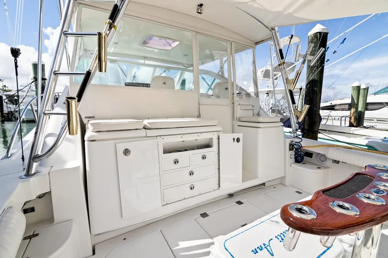 Slide: The Image of 2001 Rampage 38 Express boat interior with fishing rod holders and storage compartments. - 6