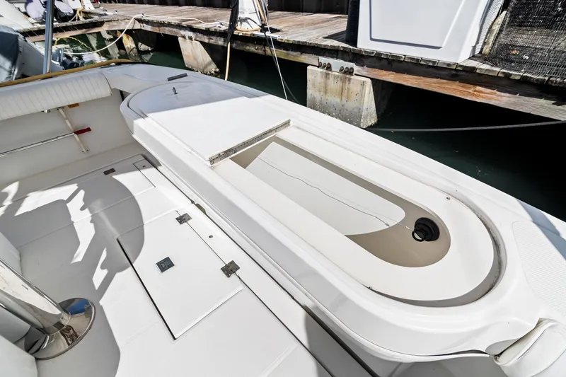 Slide: The Image of 2001 Rampage 38 Express boat interior with storage compartment, docked at marina. - 9