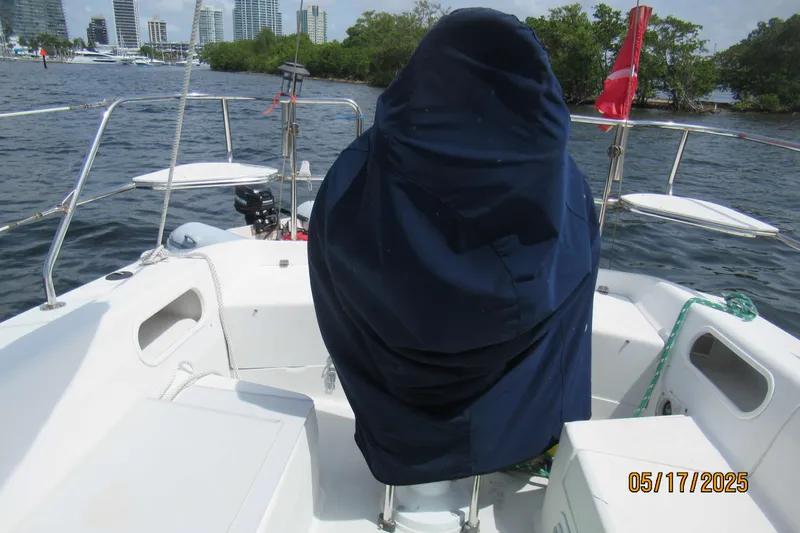 Slide: The Image of Catalina 270 sailboat cockpit with covered helm, city skyline in background, dated May 17, 2025. - 12