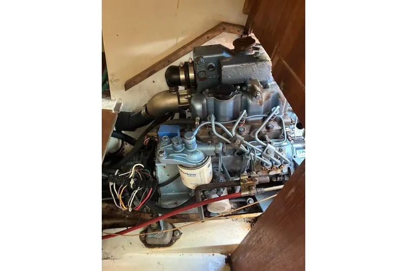 Slide: The Image of Engine of a 1995 Catalina 270 sailboat, showcasing mechanical components and wiring. - 13