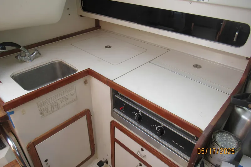 Slide: The Image of Interior of a 1995 Catalina 270 sailboat kitchen with sink and stove. - 5