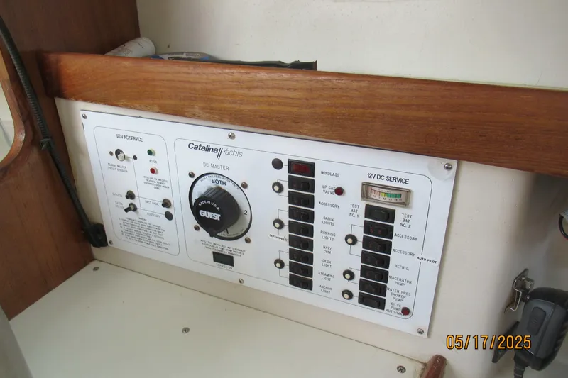 Slide: The Image of Control panel of a 1995 Catalina 270 yacht with various switches and gauges. - 7