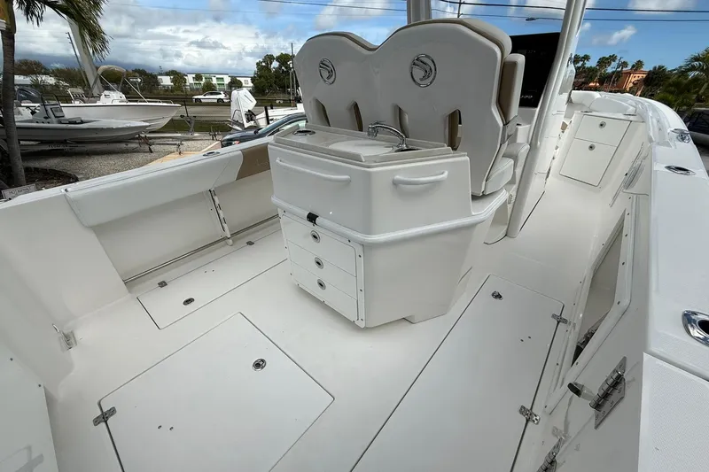 Slide: The Image of 2018 Edgewater 262CC boat interior with seating and storage compartments. - 11