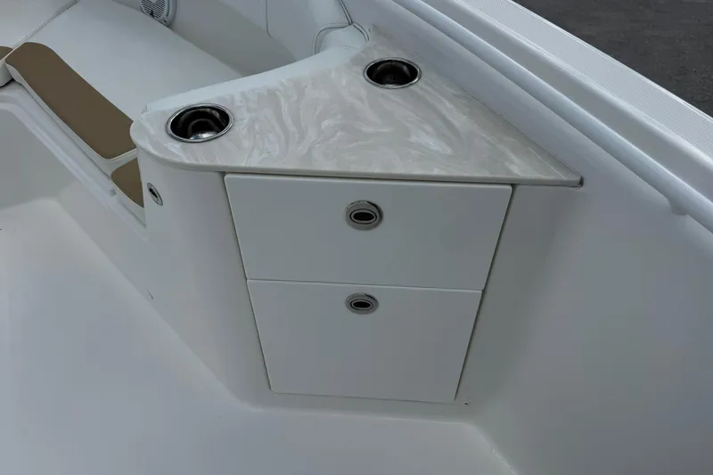 Slide: The Image of Edgewater 262CC 2018 boat interior with storage compartments and cup holders. - 25