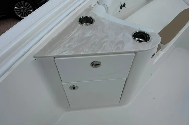 Slide: The Image of 2018 Edgewater 262CC boat interior with storage and cup holders. - 27