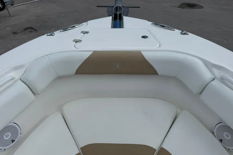 Slide: The Image of 2018 Edgewater 262CC boat interior with white and tan seating. - 29