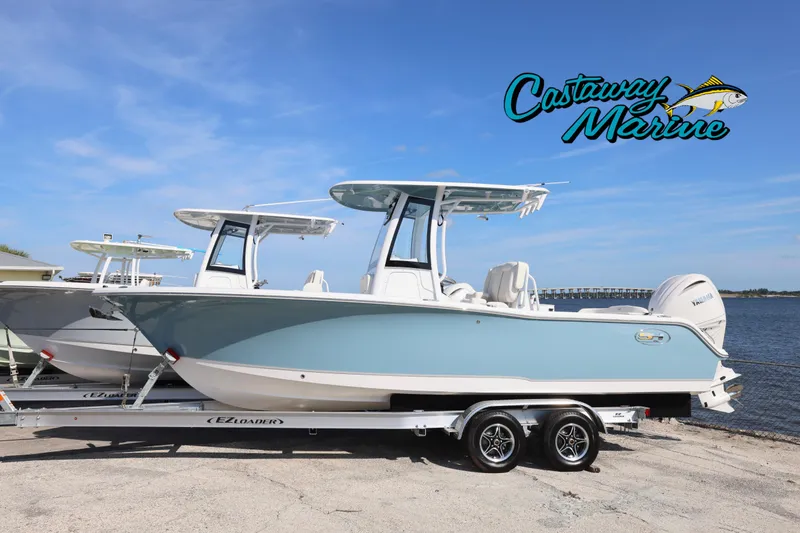 The Image of 2026 Sea Hunt Ultra 245 SE boat on trailer by Castaway Marine, waterfront view. - 0