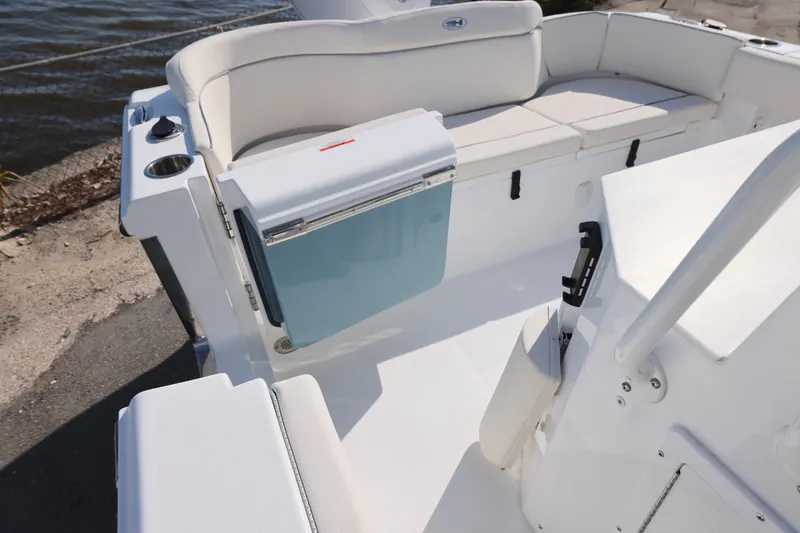 Slide: The Image of 2026 Sea Hunt Ultra 245 SE boat interior with seating and storage compartments. - 11