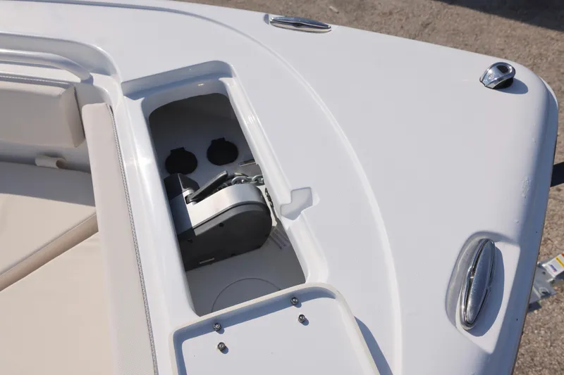 Slide: The Image of 2026 Sea Hunt Ultra 245 SE boat anchor compartment with sleek design and chrome fittings. - 14