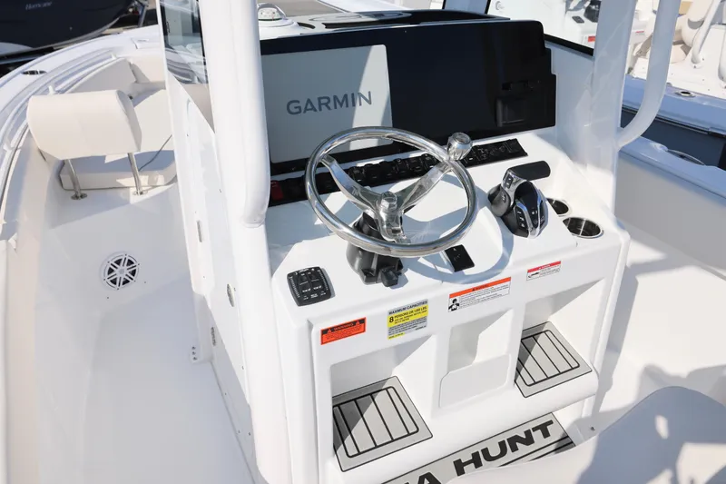 Slide: The Image of 2026 Sea Hunt Ultra 245 SE boat console with Garmin navigation system and steering wheel. - 15