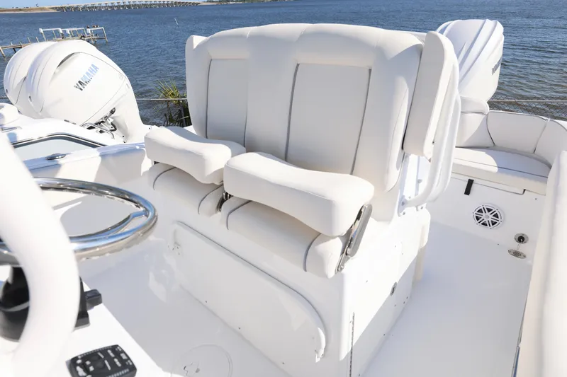 Slide: The Image of 2026 Sea Hunt Ultra 245 SE boat interior with white seating and Yamaha engines. - 16