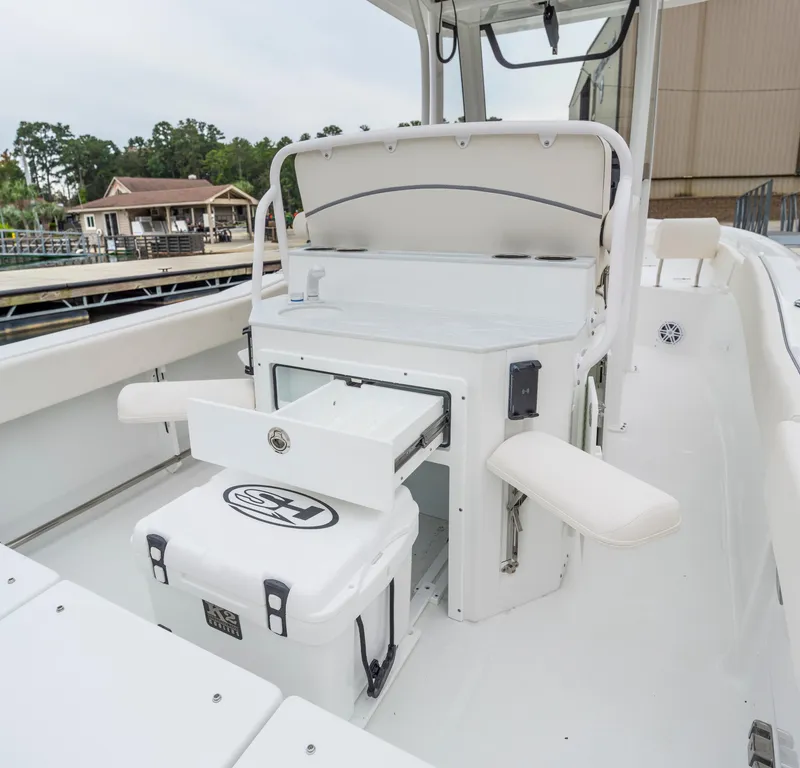 Slide: The Image of 2026 Sea Hunt Ultra 245 SE boat interior with storage and seating features. - 27