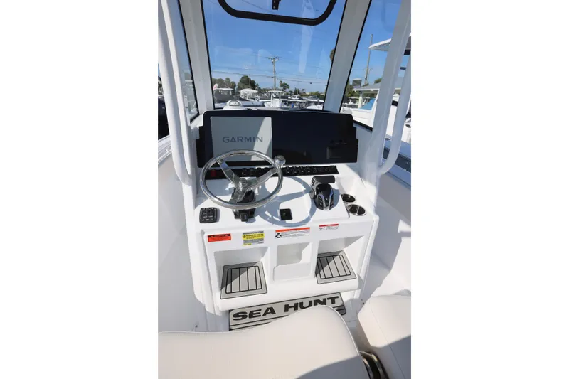 Slide: The Image of 2026 Sea Hunt Ultra 245 SE boat console with Garmin navigation system and steering wheel. - 4