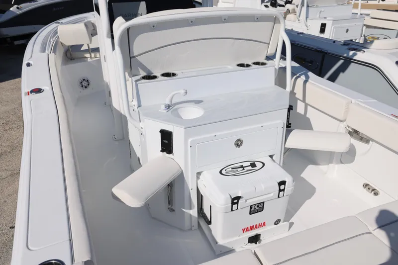 Slide: The Image of 2026 Sea Hunt Ultra 245 SE boat interior with seating, sink, and cooler. - 5