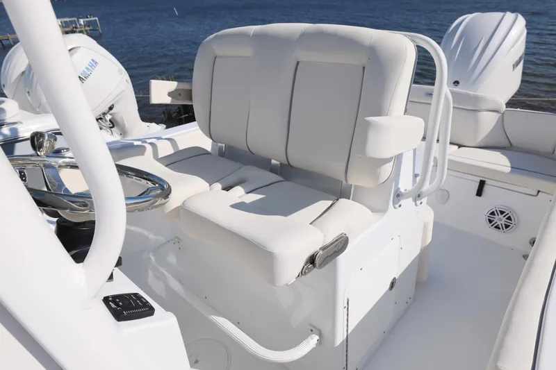 Slide: The Image of 2026 Sea Hunt Ultra 245 SE boat interior with white seating and steering wheel. - 7
