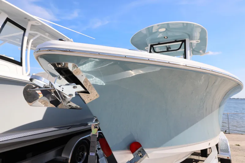 Slide: The Image of 2026 Sea Hunt Ultra 245 SE boat on trailer, sunny day, close-up view. - 9