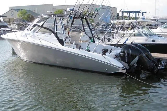 Slide: The Image of 2007 Fountain 33 Sportfish Cruiser control panel with chrome throttle and steering wheel. - 11