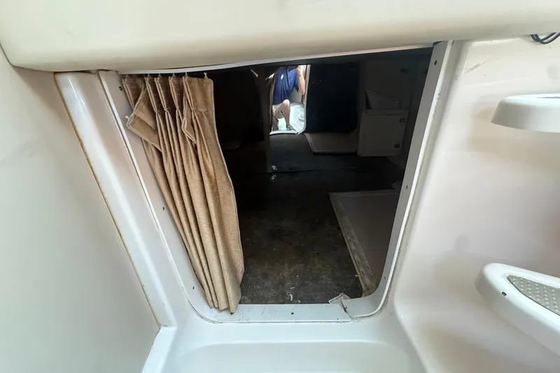 Slide: The Image of 2007 Fountain 33 Sportfish Cruiser cabin entrance with curtain and interior view. - 22