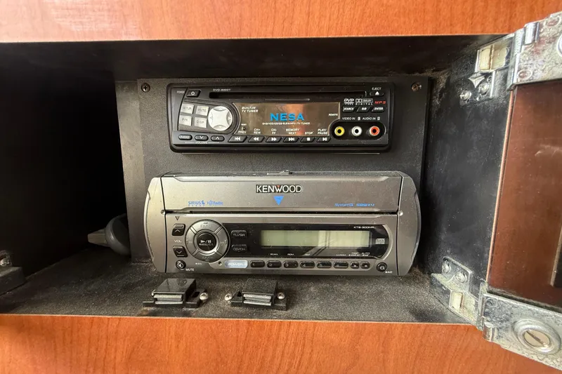 Slide: The Image of 2007 Fountain 33 Sportfish Cruiser audio system with Kenwood and NESA units in wooden cabinet. - 23