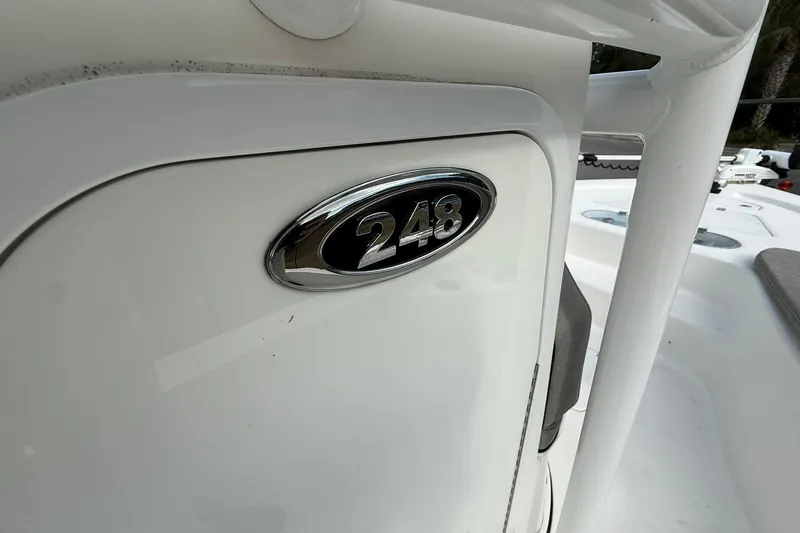 Slide: The Image of 2021 Sea Pro 248 Bay boat emblem on white surface. - 17