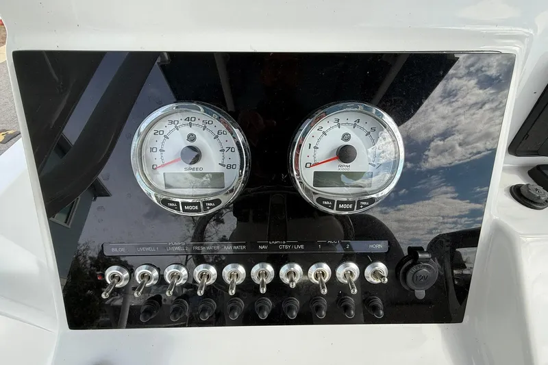 Slide: The Image of 2021 Sea Pro 248 Bay dashboard with speedometer, RPM gauge, and control switches. - 19