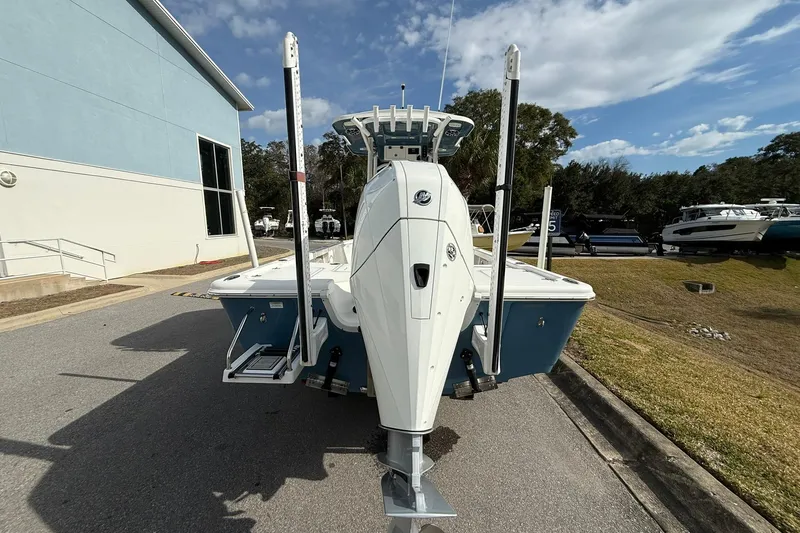 Slide: The Image of 2021 Sea Pro 248 Bay boat, rear view, parked outdoors near a building. - 2