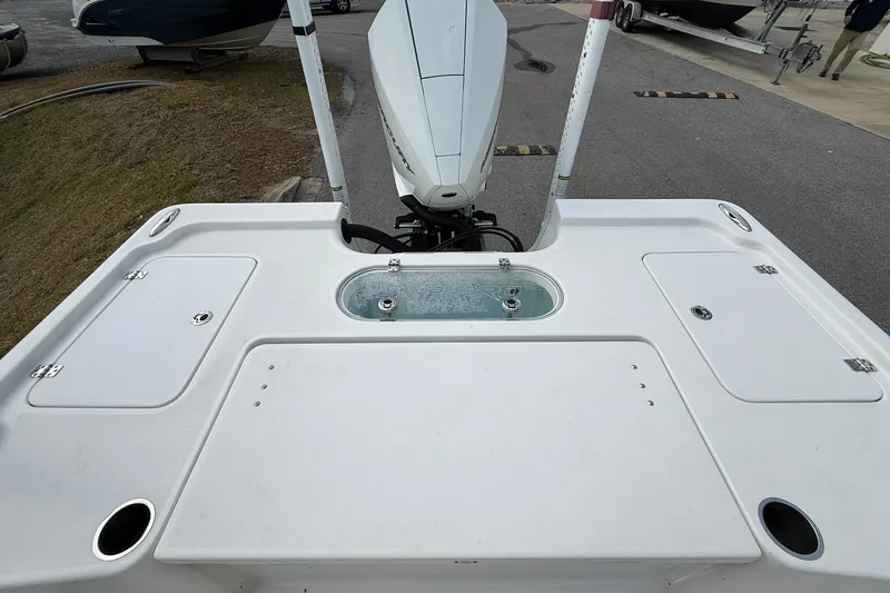Slide: The Image of 2021 Sea Pro 248 Bay boat deck with storage compartments and motor. - 22