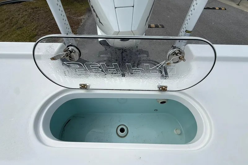 Slide: The Image of 2021 Sea Pro 248 Bay boat livewell with clear lid and drainage system. - 25