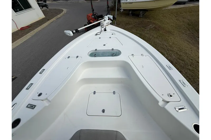 Slide: The Image of 2021 Sea Pro 248 Bay boat deck with storage compartments and trolling motor. - 5