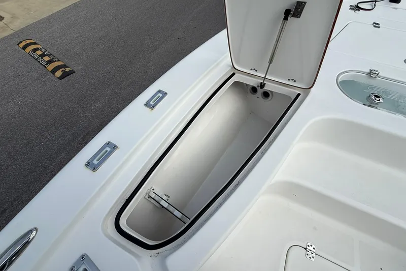 Slide: The Image of 2021 Sea Pro 248 Bay boat storage compartment open on deck. - 6