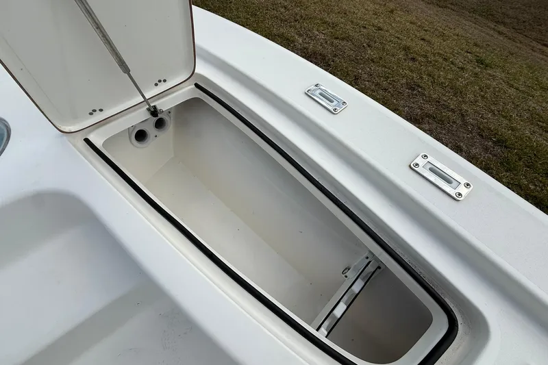 Slide: The Image of Open storage compartment on 2021 Sea Pro 248 Bay boat, showcasing interior space. - 7
