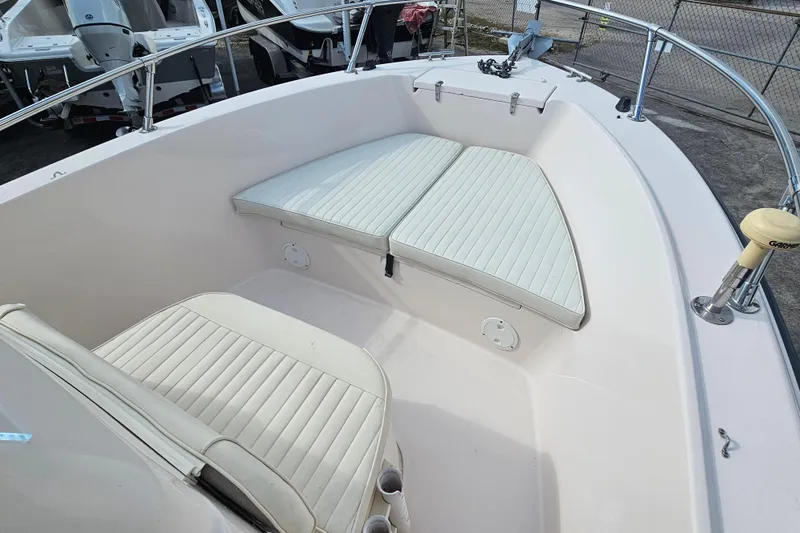 Slide: The Image of 2001 Grady-White Sportsman 180 boat interior with cushioned seating and stainless steel railings. - 14
