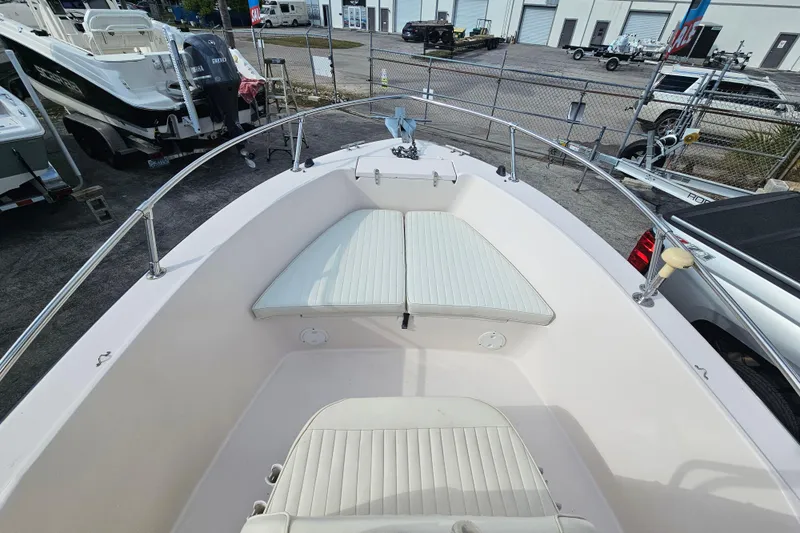 Slide: The Image of 2001 Grady-White Sportsman 180 boat interior with seating, docked in a marina. - 15