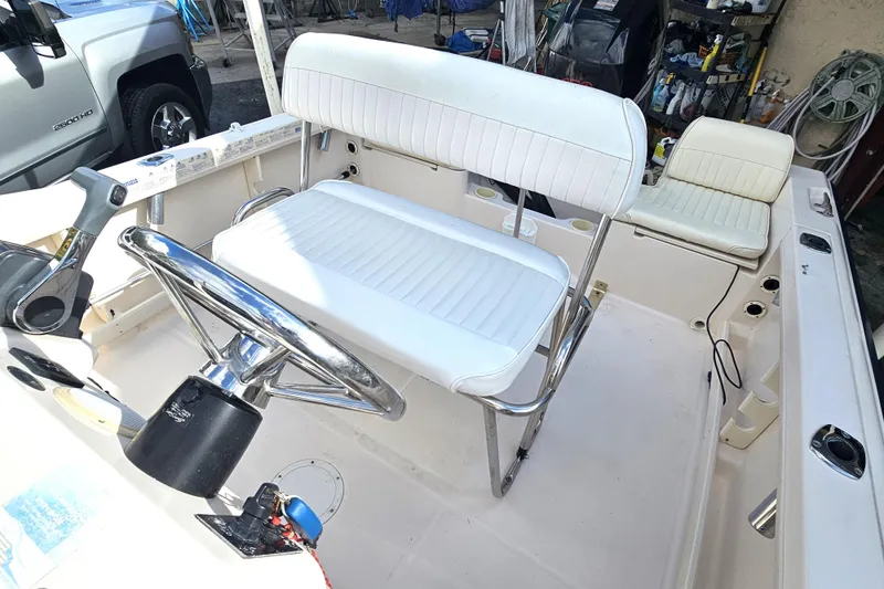Slide: The Image of 2001 Grady-White Sportsman 180 boat interior with white seating and steering wheel. - 18