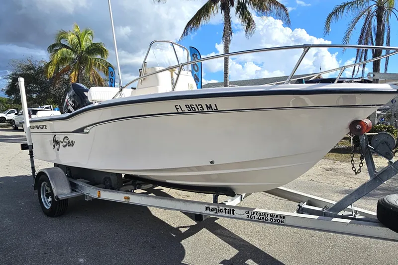 Slide: The Image of 2001 Grady-White Sportsman 180 boat on trailer, palm trees in background. - 2