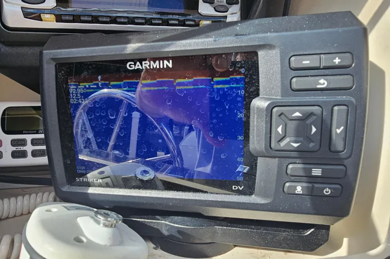 Slide: The Image of Garmin fishfinder on 2001 Grady-White Sportsman 180 boat dashboard, displaying sonar data. - 23