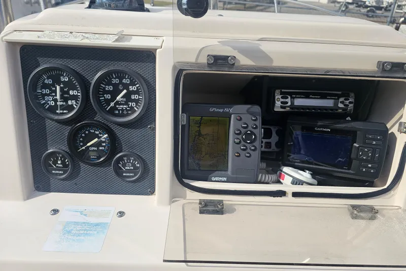Slide: The Image of Dashboard of 2001 Grady-White Sportsman 180 with gauges and Garmin GPS devices. - 25