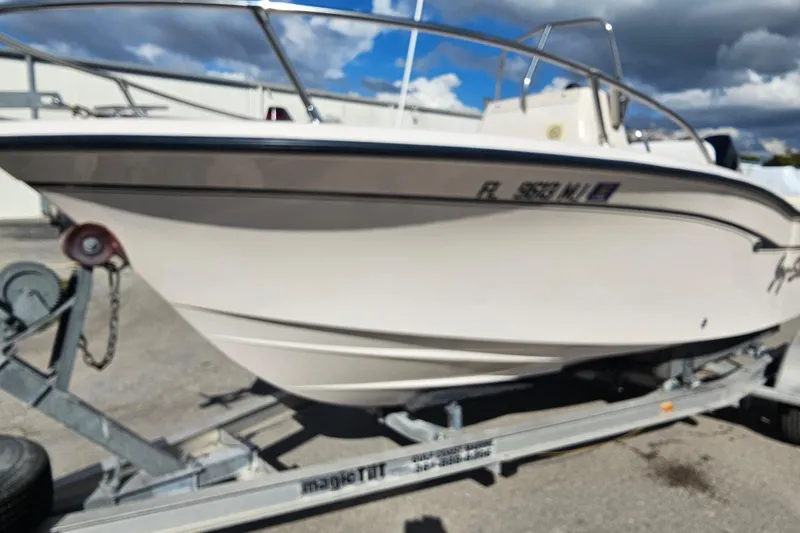 Slide: The Image of 2001 Grady-White Sportsman 180 boat on trailer, parked outdoors under cloudy sky. - 3