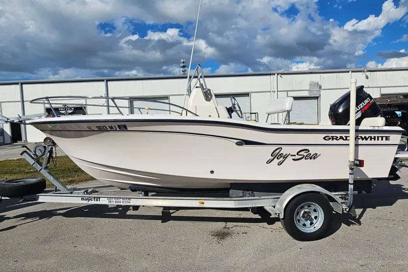 Slide: The Image of 2001 Grady-White Sportsman 180 boat on trailer, named "Joy-Sea," with Suzuki outboard motor. - 4