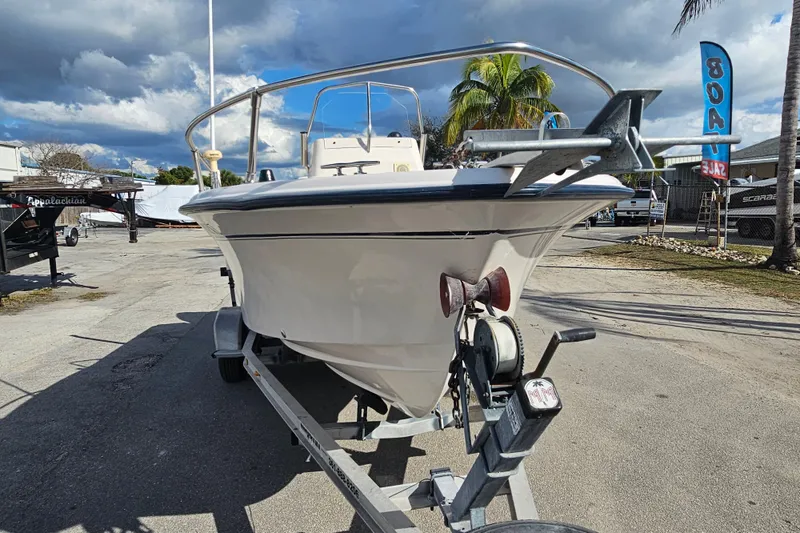 Slide: The Image of 2001 Grady-White Sportsman 180 boat on trailer, parked outdoors under cloudy sky. - 5