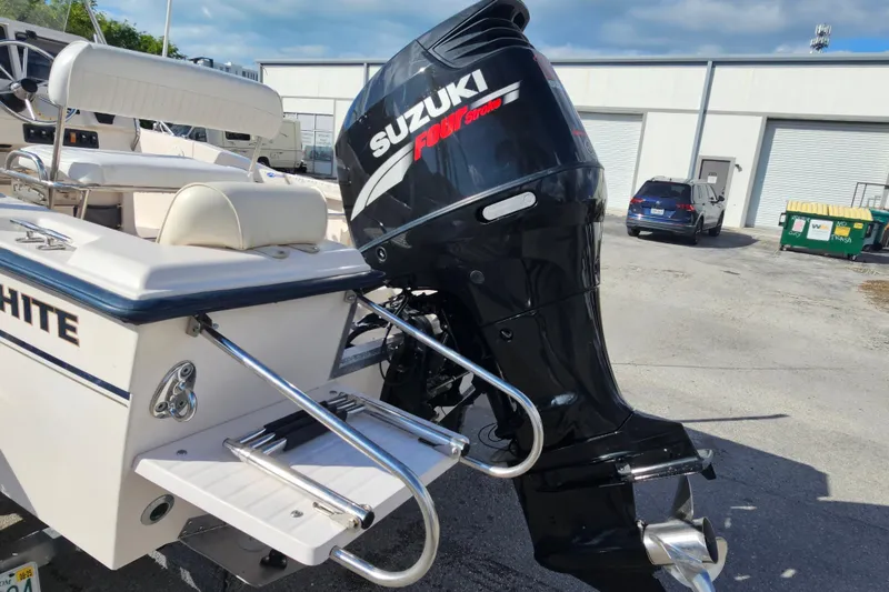 Slide: The Image of 2001 Grady-White Sportsman 180 boat with Suzuki outboard motor in a marina setting. - 8