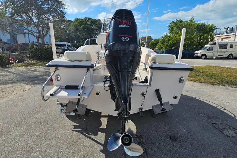 Slide: The Image of 2001 Grady-White Sportsman 180 boat with Suzuki 150 outboard motor, parked outdoors. - 9