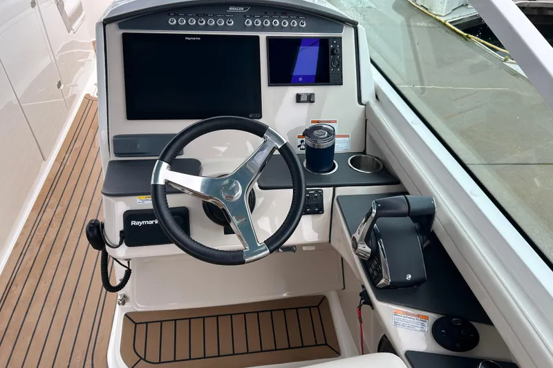 Slide: The Image of 2022 Boston Whaler 320 Vantage helm with Raymarine electronics and modern steering wheel. - 2