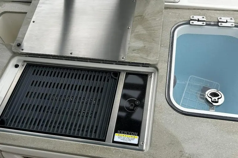 Slide: The Image of Boston Whaler 320 Vantage 2022 boat grill and sink setup. - 4