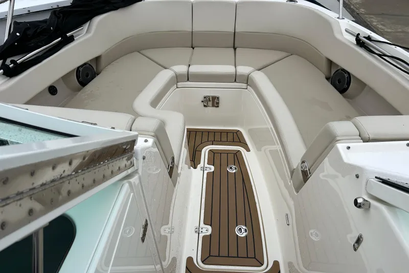 Slide: The Image of 2022 Boston Whaler 320 Vantage boat interior with cushioned seating and teak flooring. - 9