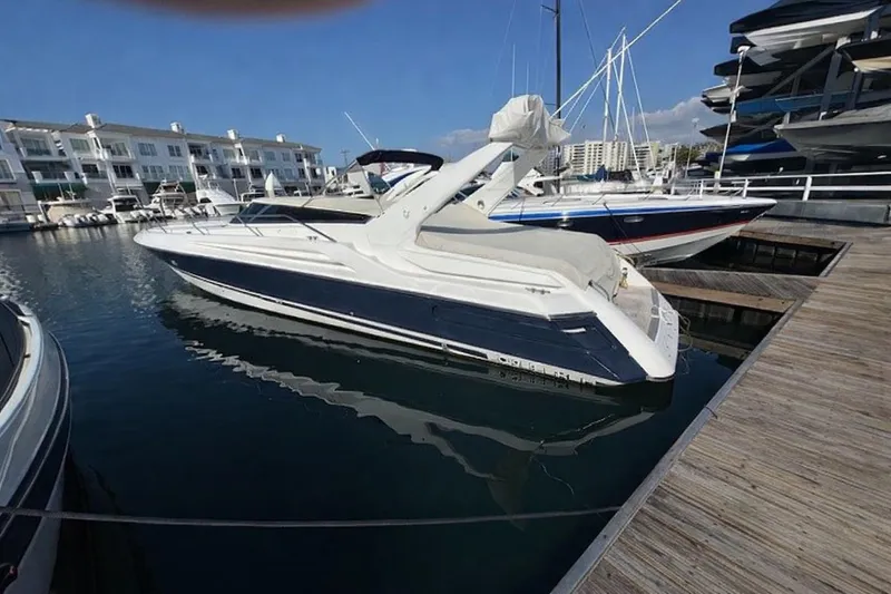 The Image of 1994 Sunseeker Apache 45 yacht docked at marina, surrounded by other boats. - 0